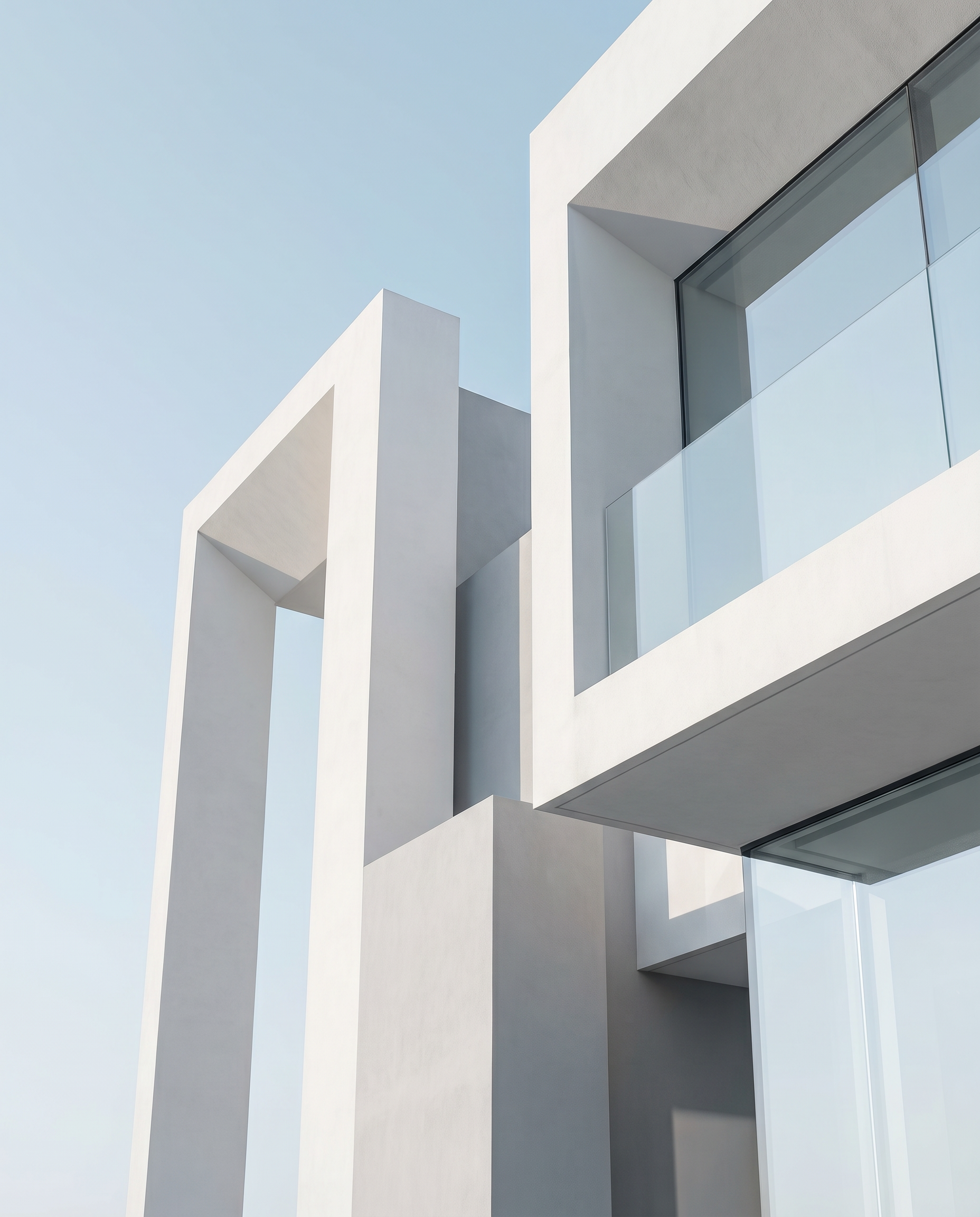Modern minimalist architecture — clean geometric forms against a pale sky